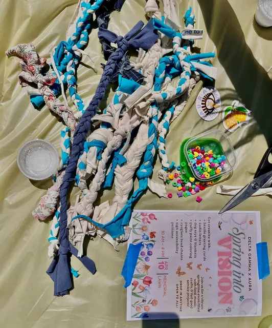 Braided fabric strips, beads and a printed worksheet laid out for a craft activity.