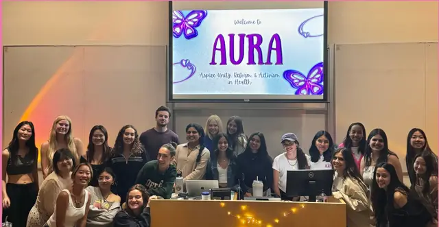 AURA members gathered for a group photo in front of a welcome slide bearing the club's name.